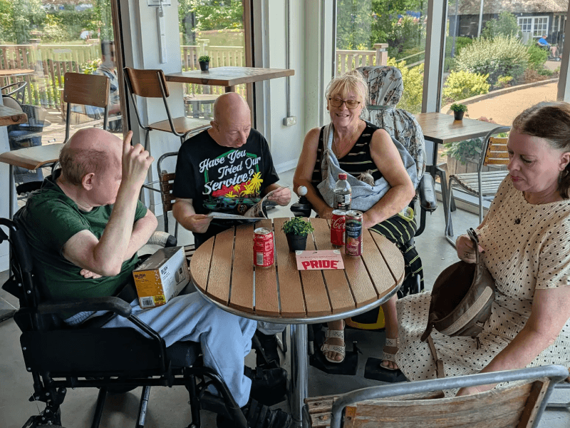 Friends and family chatting around a café table