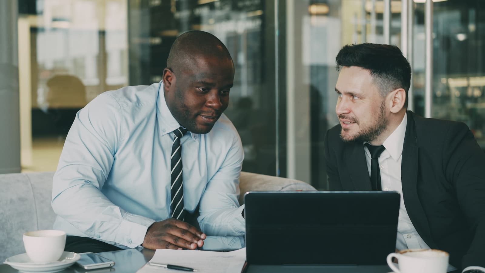 Two professionals reviewing a referral together in an office